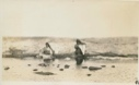Image of A couple washing skins at water's edge